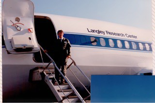Business professional boarding private jet at Langley Research Center.